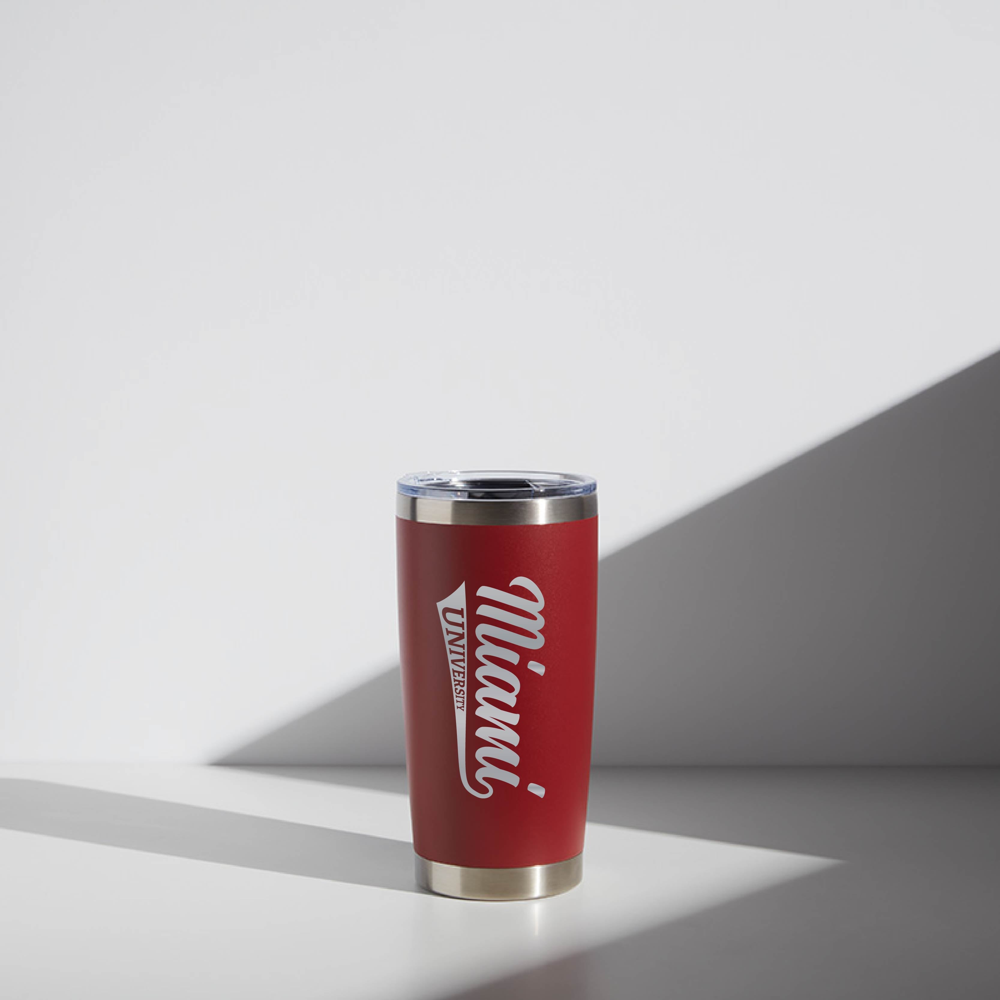 Red 20 oz WATR Tumbler with Miami University script logo, stainless steel rim and base, displayed in a minimalist setting with a shadow line.