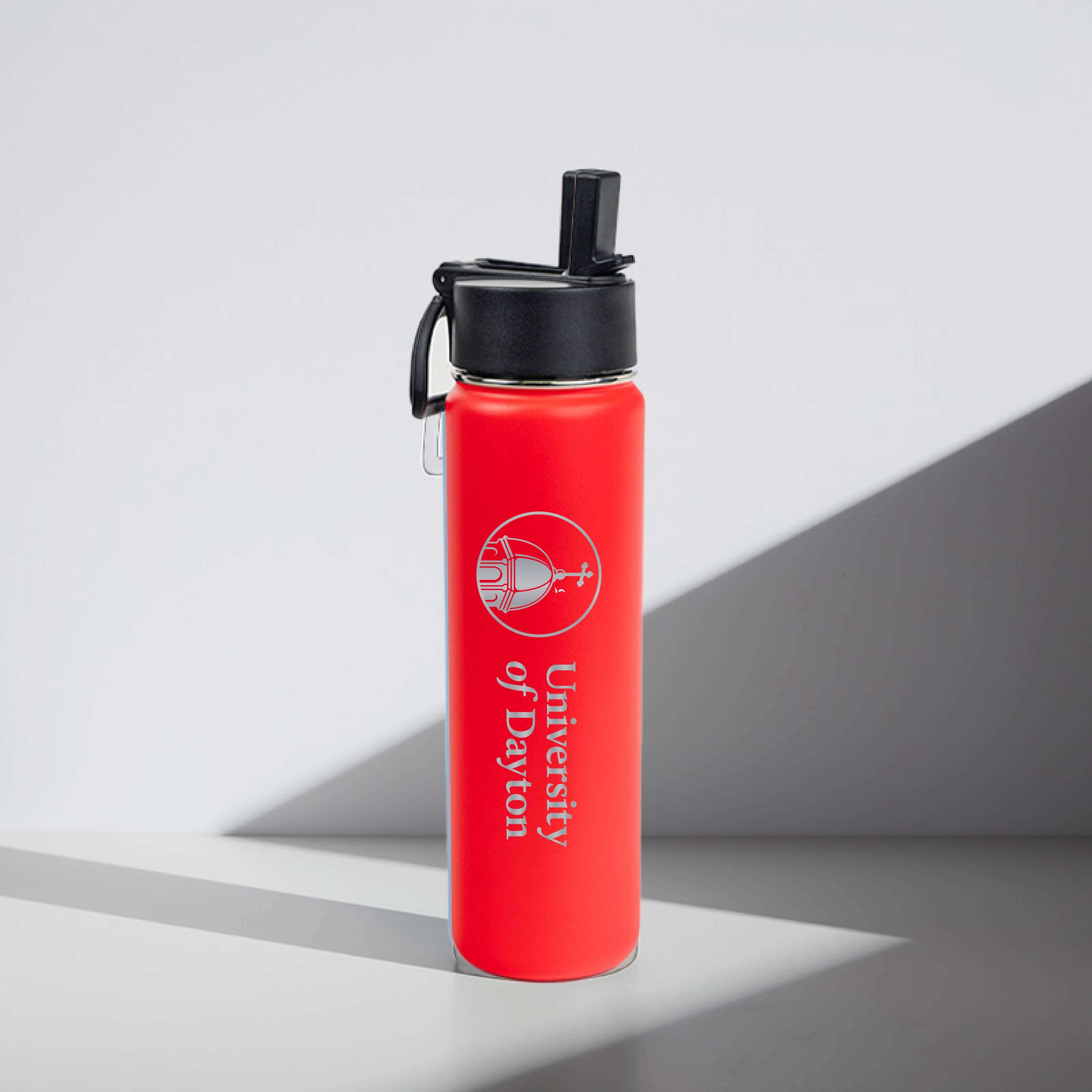 Red water bottle with black lid featuring 'University of Dayton' logo on a gray background