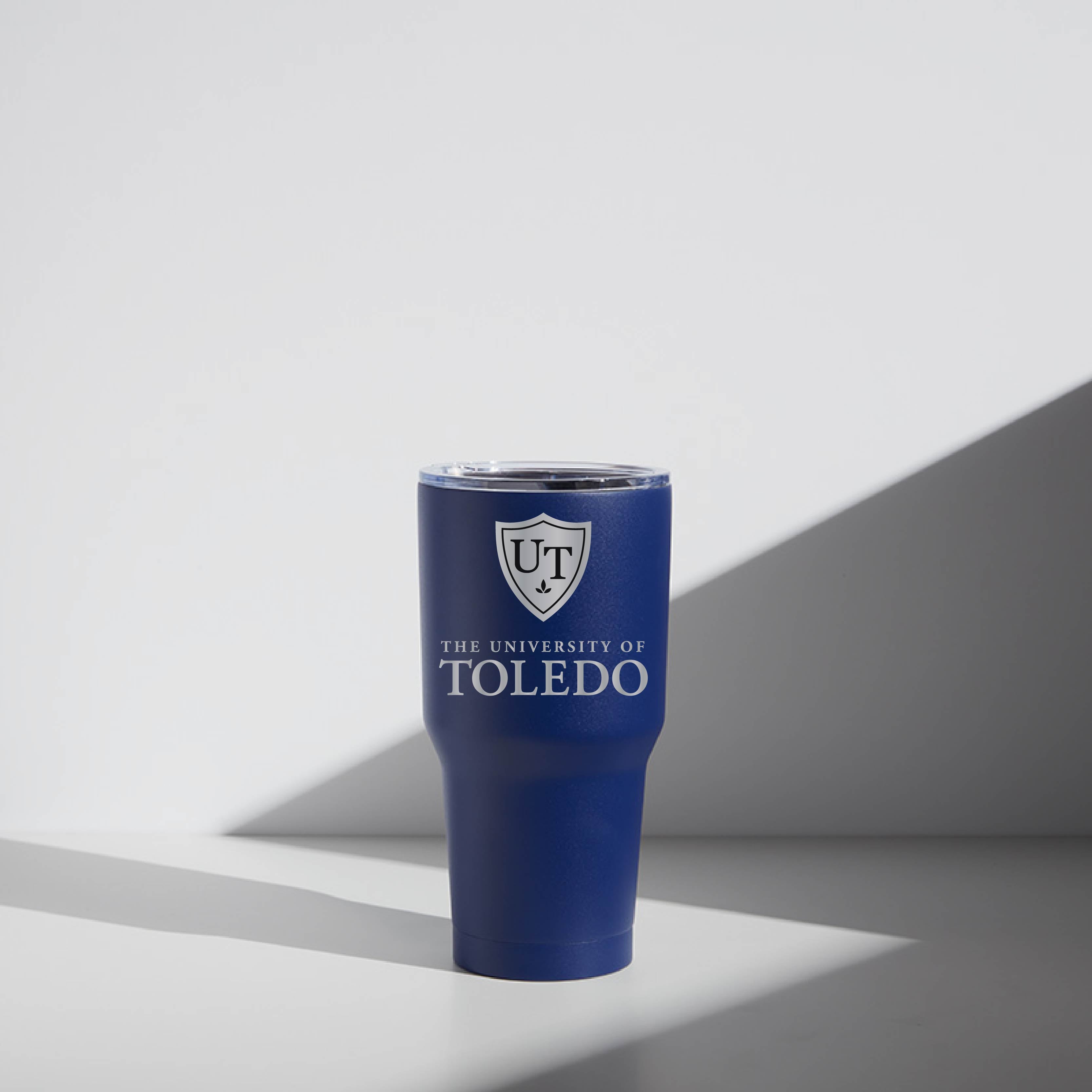 A blue 30 oz stainless steel tumbler with a magnetic lid, featuring the University of Toledo logo.