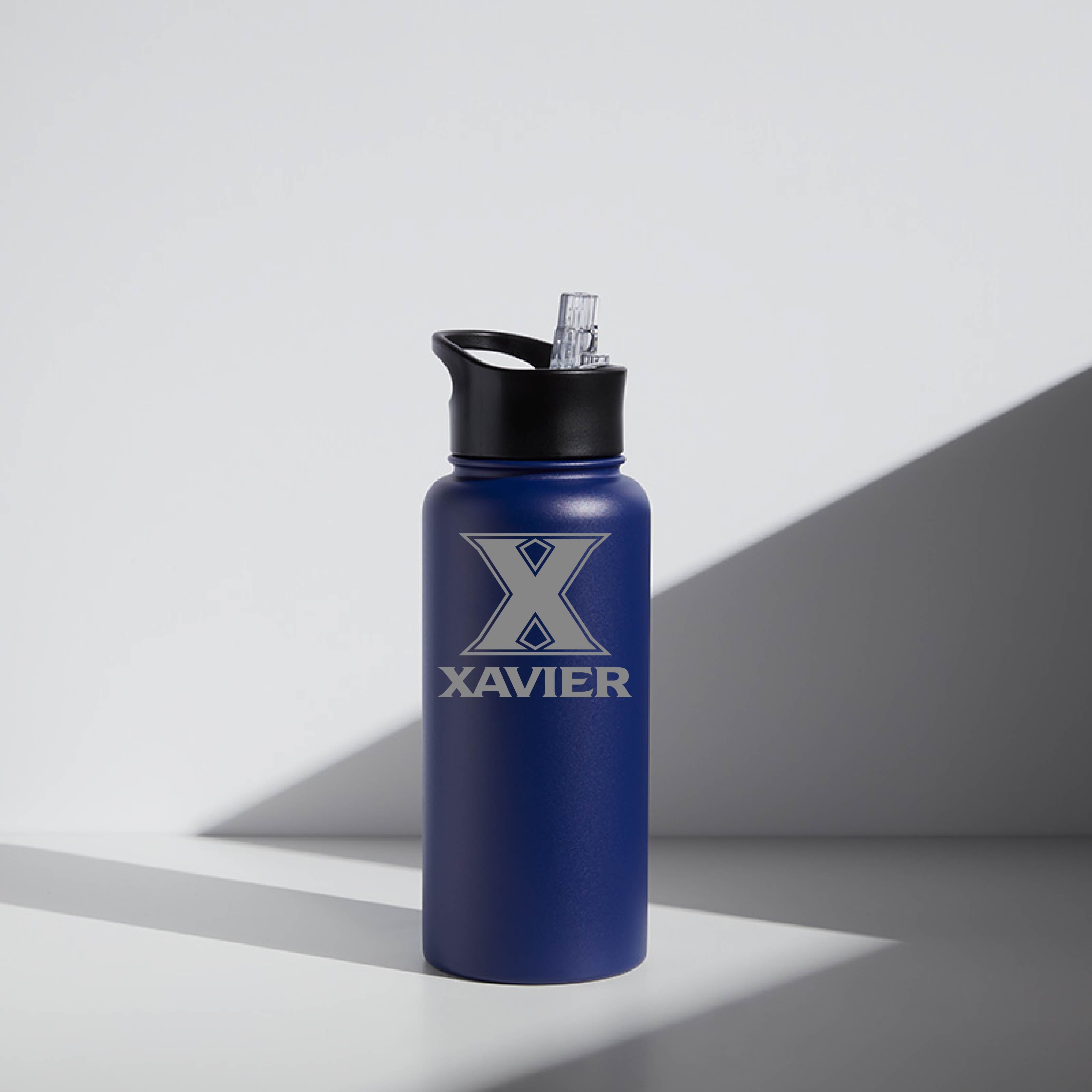 A blue 32 oz stainless steel water bottle with a 'Xavier' logo on the front and a screw-top lid.