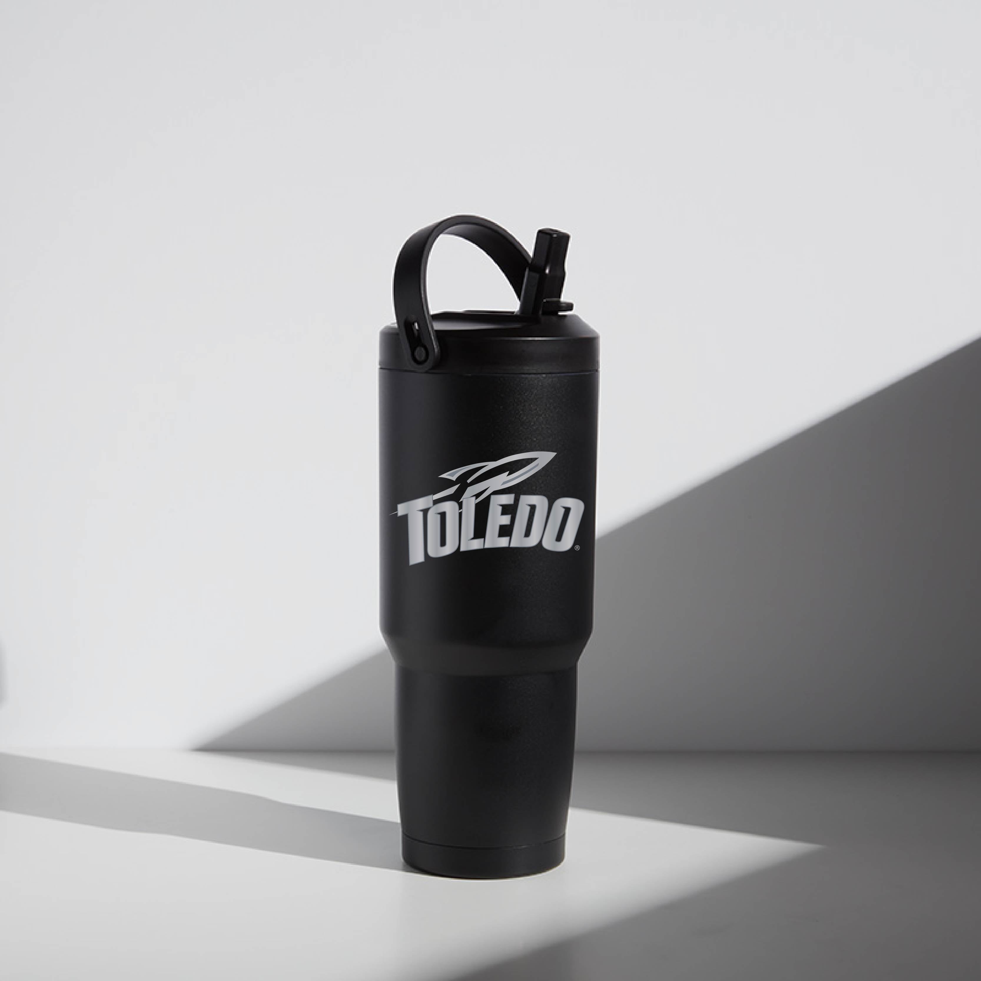 A black 32 oz stainless steel tumbler with a screw-top lid and straw, featuring University of Toledo with the text 'TOLEDO' on the side.