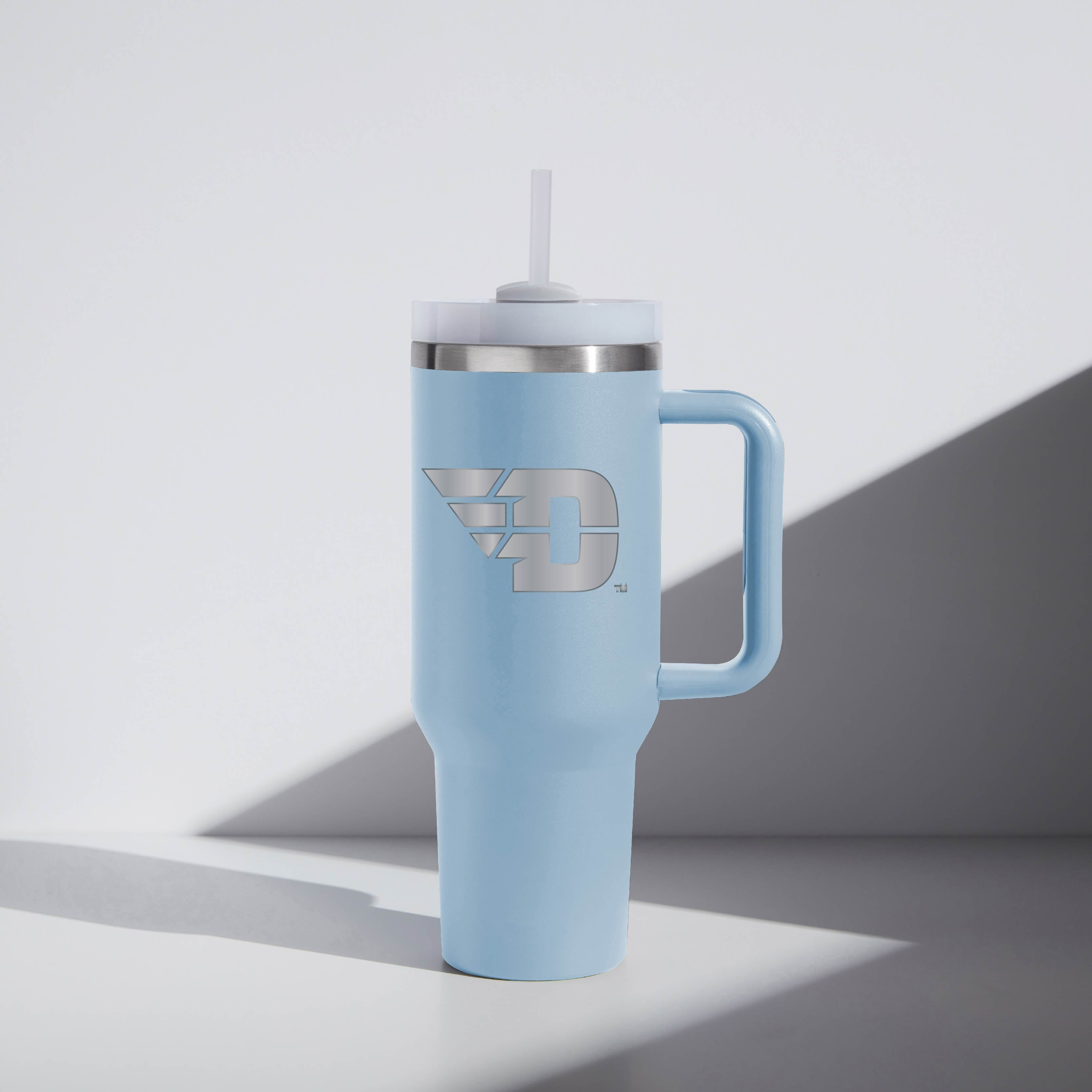 University of Dayton "Flying D" Light blue tumbler with a handle and straw lid on a white background