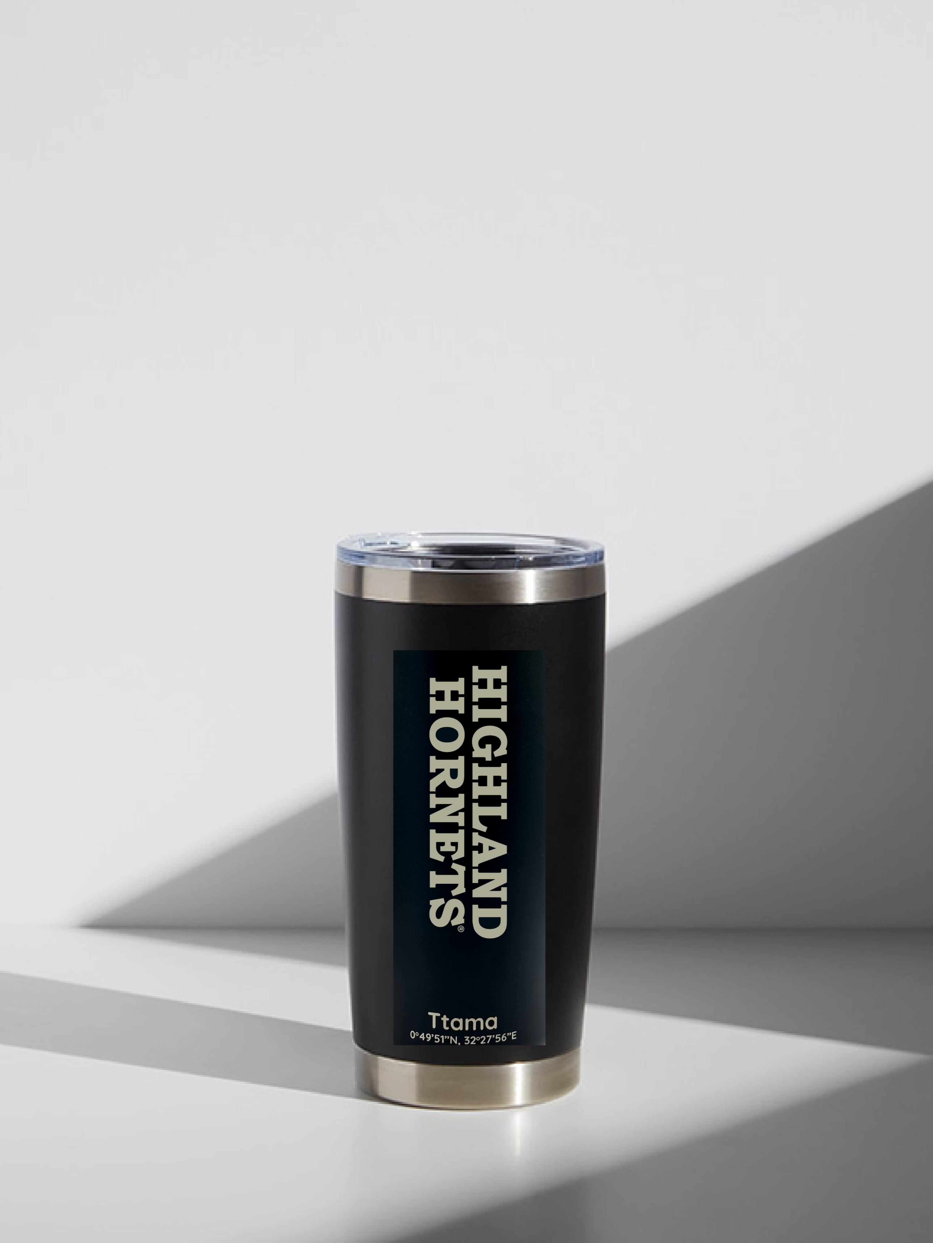 Black tumbler with 'Highland Hornets' text on a light gray background