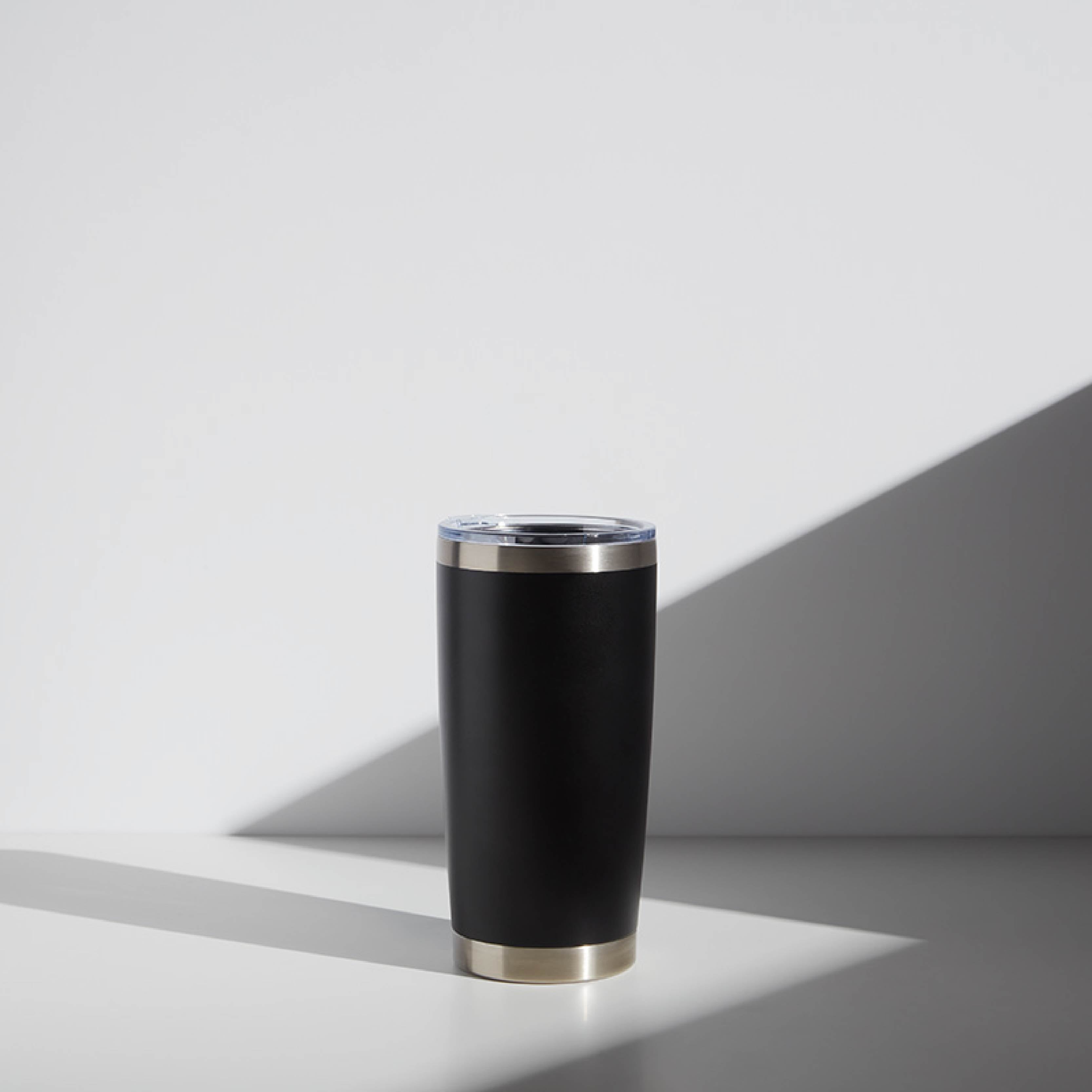 20 oz personalized black tumbler with clear lid, ideal as a teacher gift, displayed on a light gray background with shadow play.