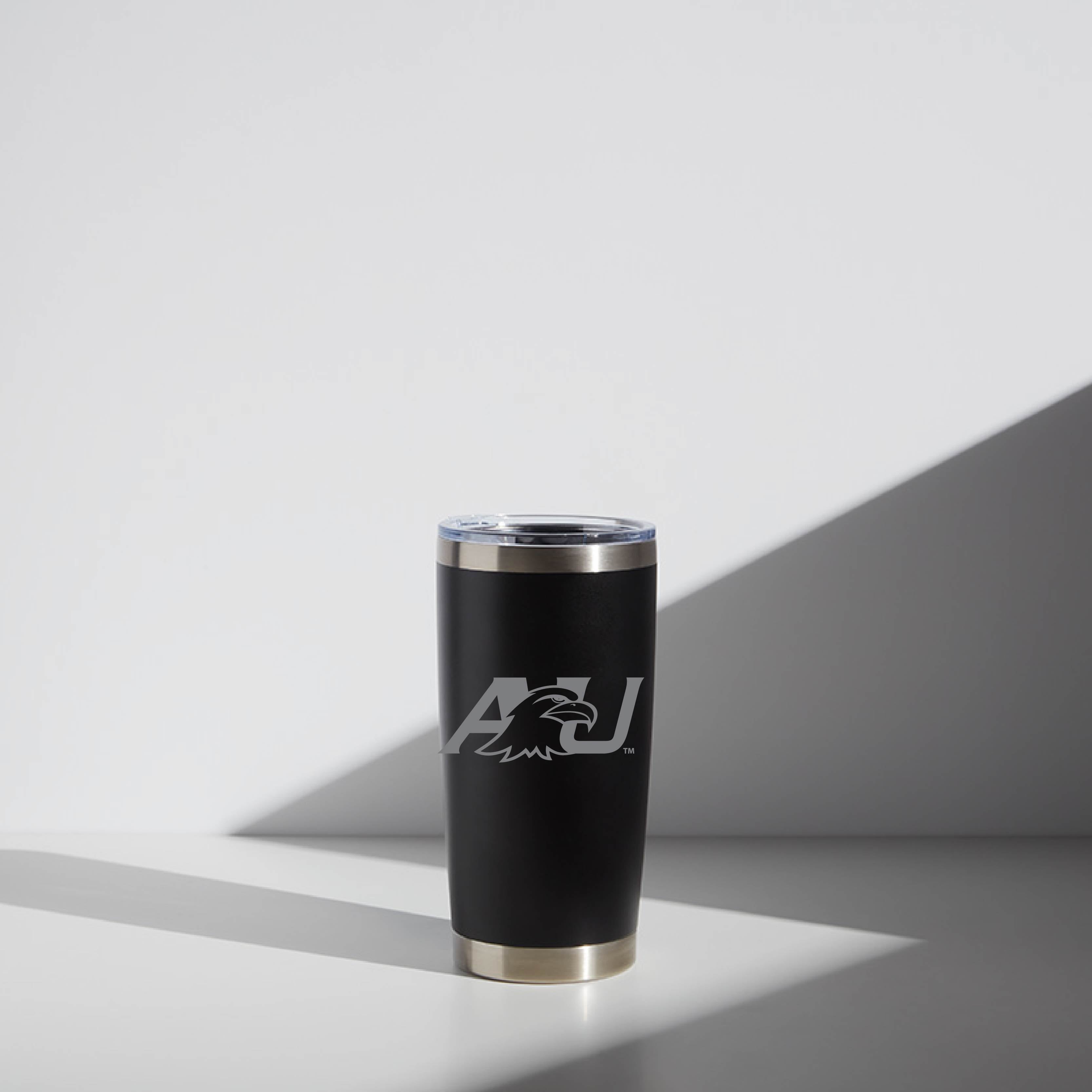 Alt text: "Ashland University branded 20 oz WATR tumbler in black with a silver logo and trim, displayed under soft lighting."