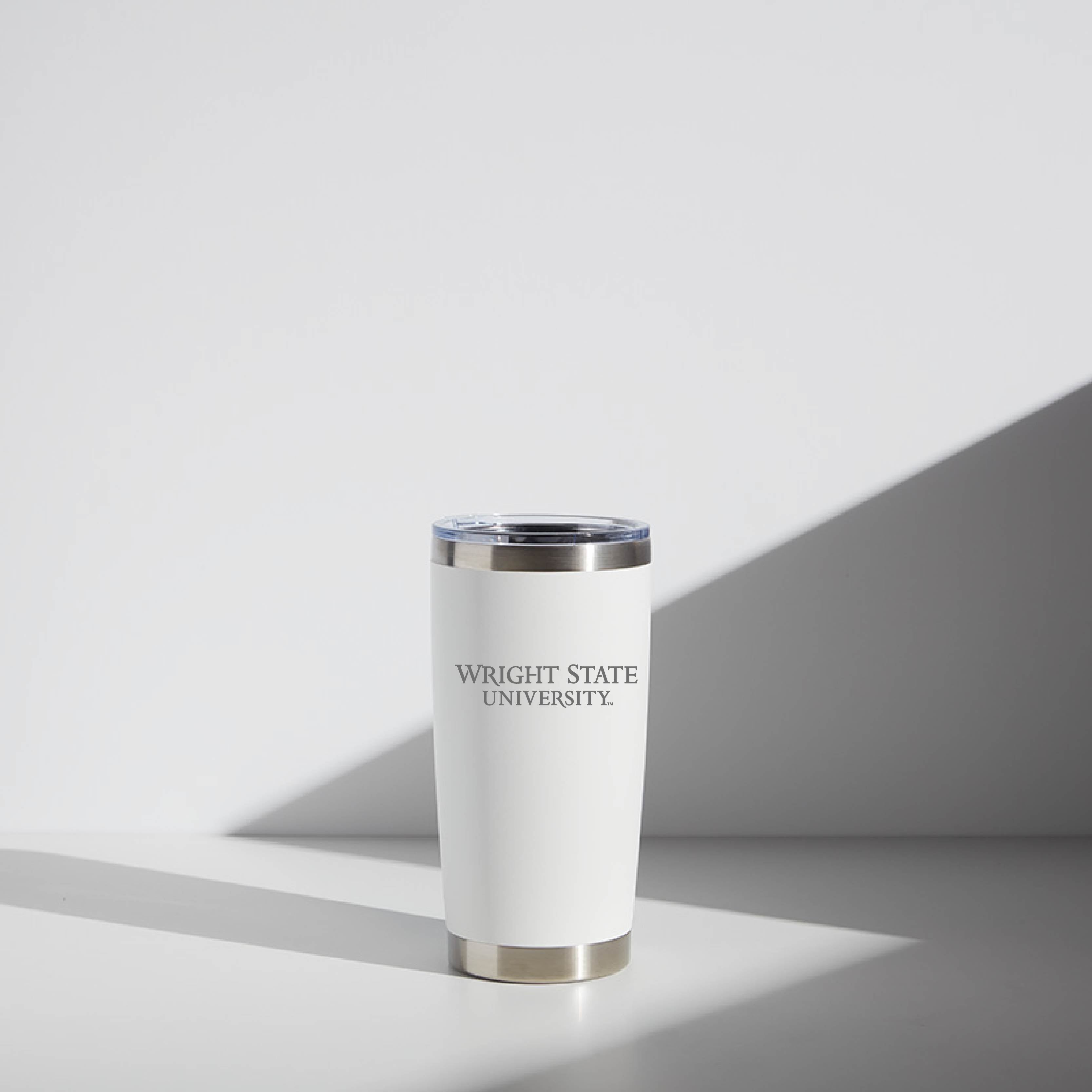 Alt text: "20 oz WATR brand tumbler in white, featuring the Wright State University logo printed in black on the body, with a stainless steel rim and base, displayed in a softly lit setting."