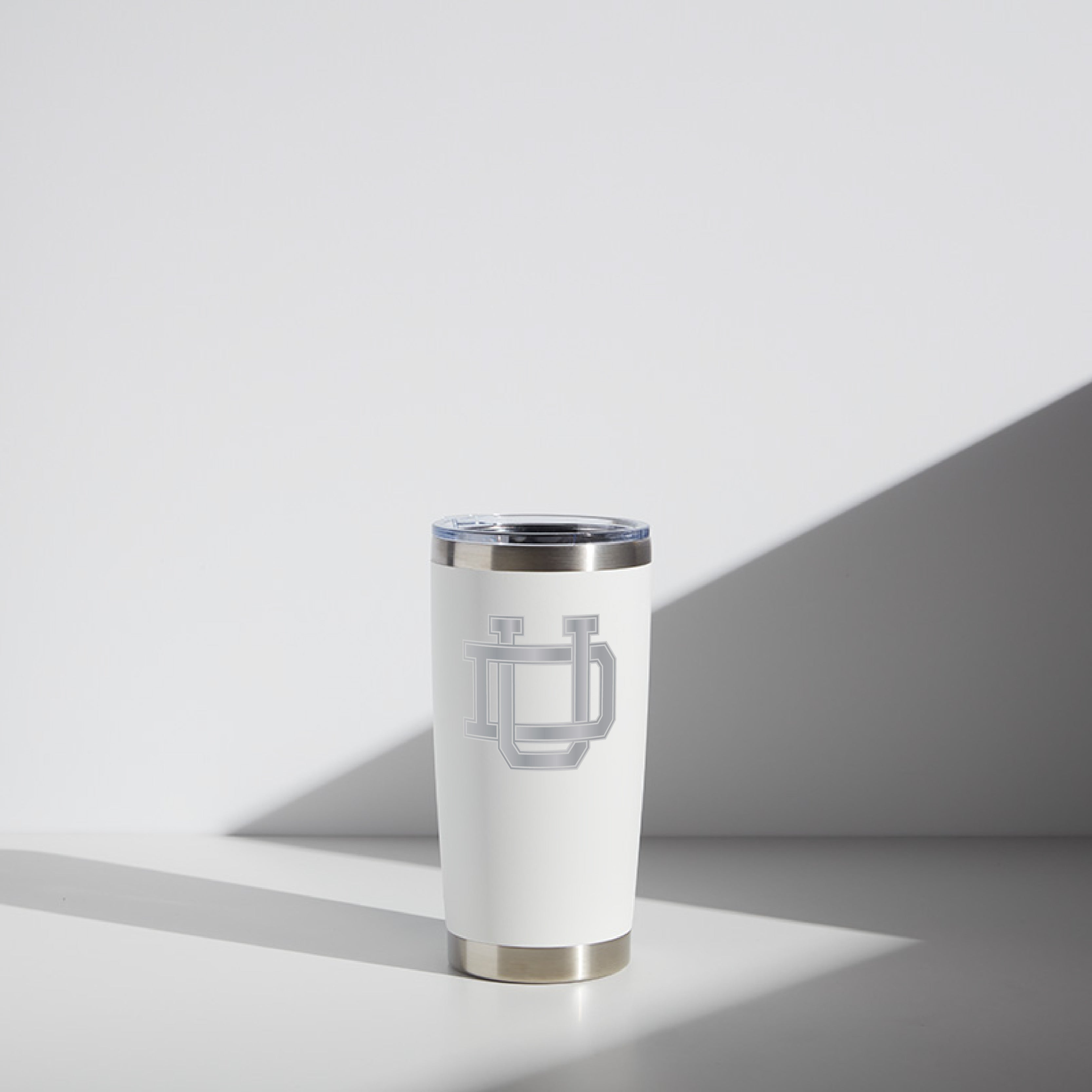 20 oz white WATR Tumbler featuring the Dayton Interlocking UD logo in gray, displayed against a subtly shadowed white background.