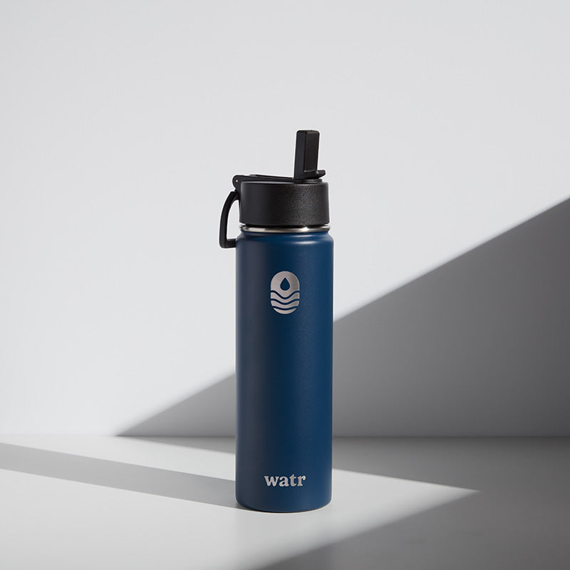 A blue 22 oz water bottle with a black lid and a straw, branded with the name 'WATR' on the front.