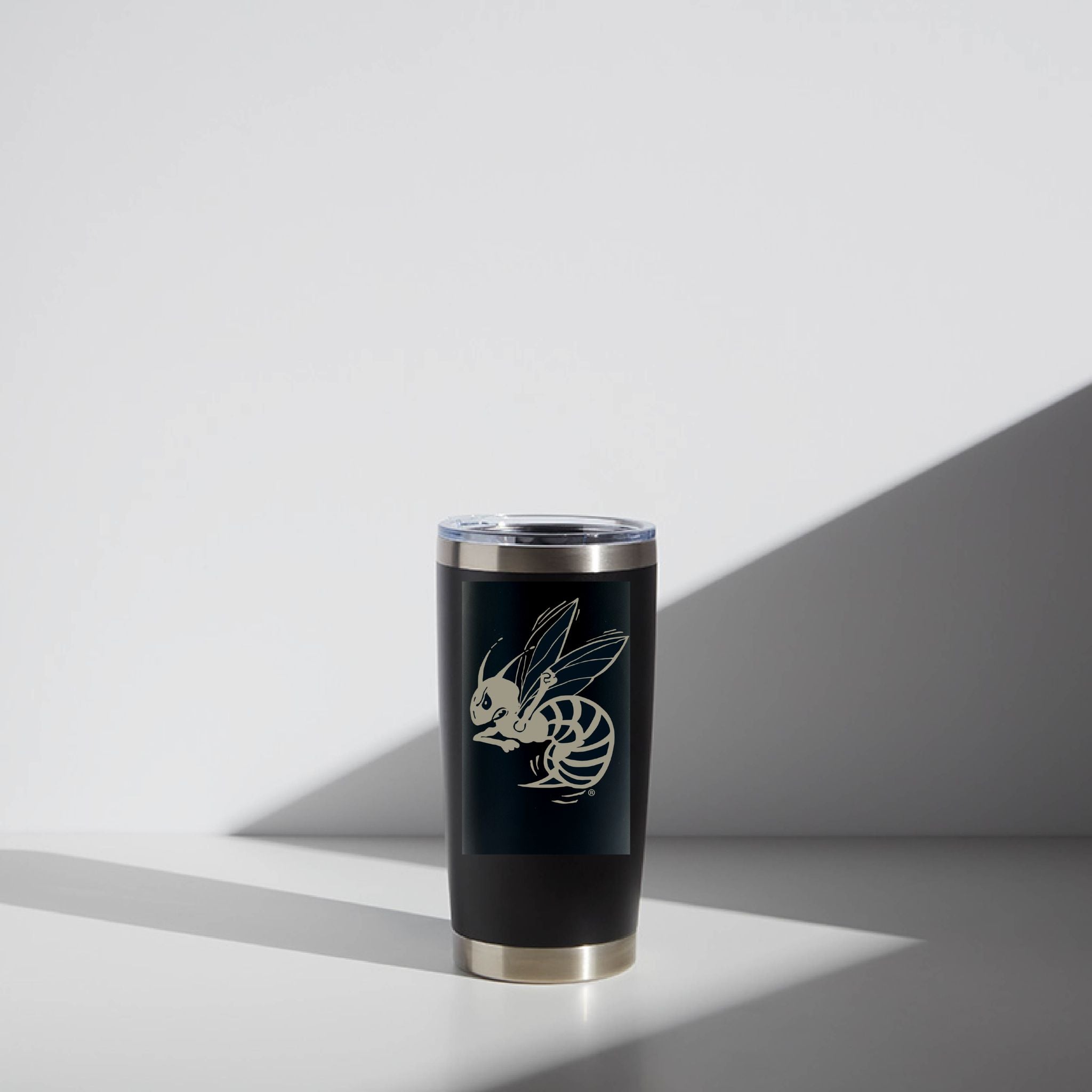 Black tumbler with a white logo on a light gray background