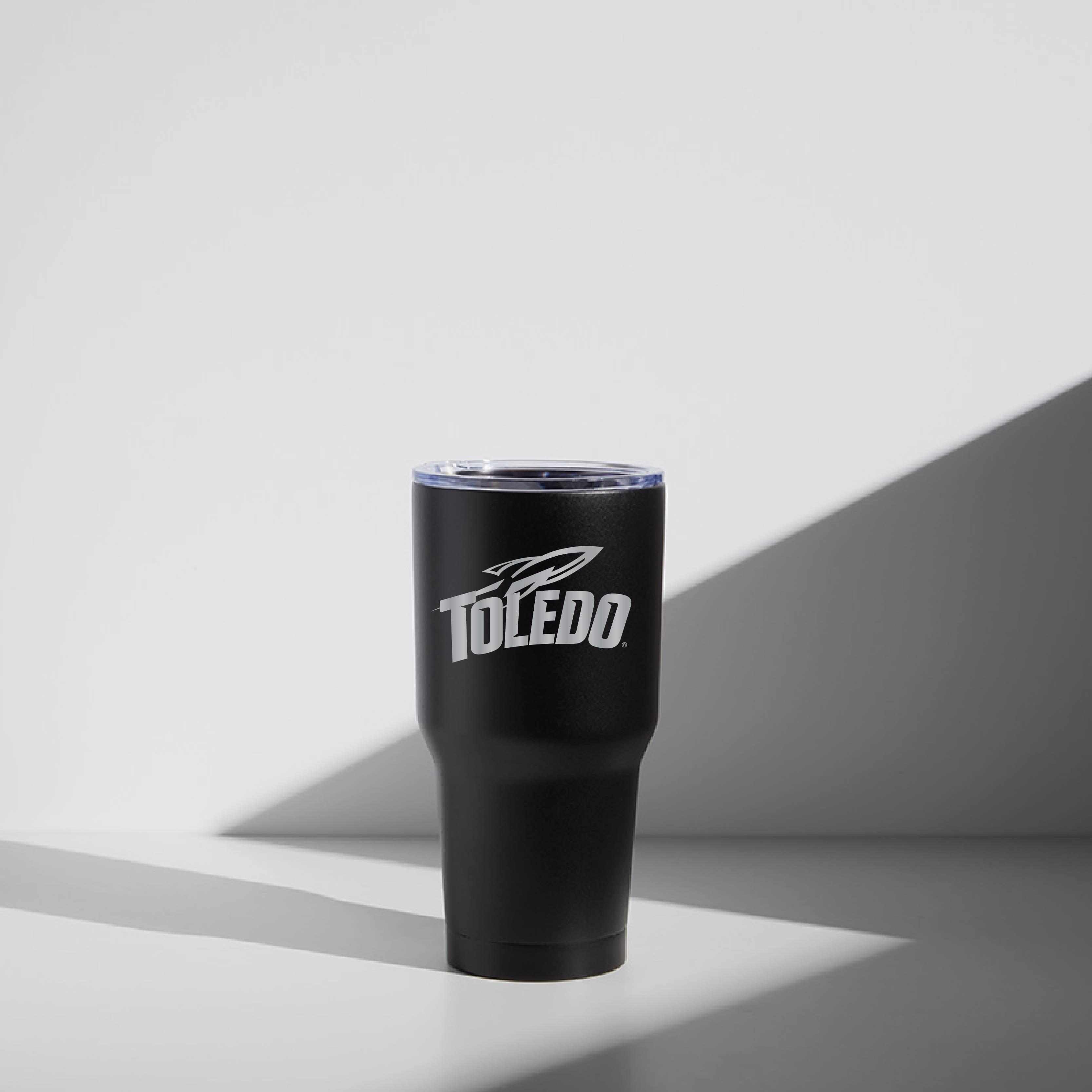 A black 30 oz stainless steel tumbler with 'Toledo' text and logo printed on the side, featuring a magnetic lid.