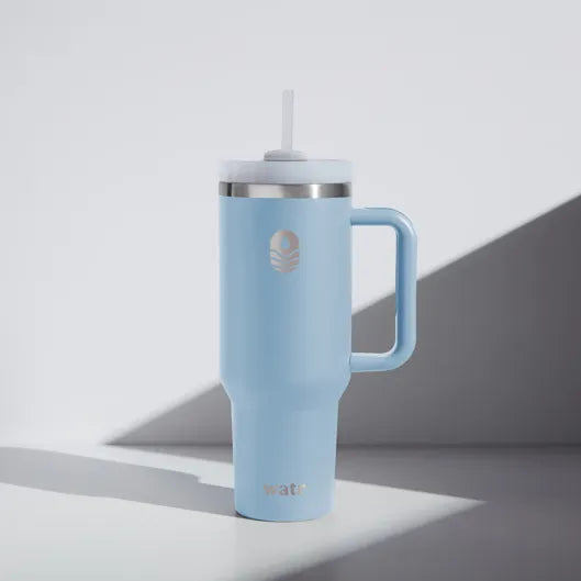 We Are The Ripple Light blue insulated mug with handle and straw on a white background