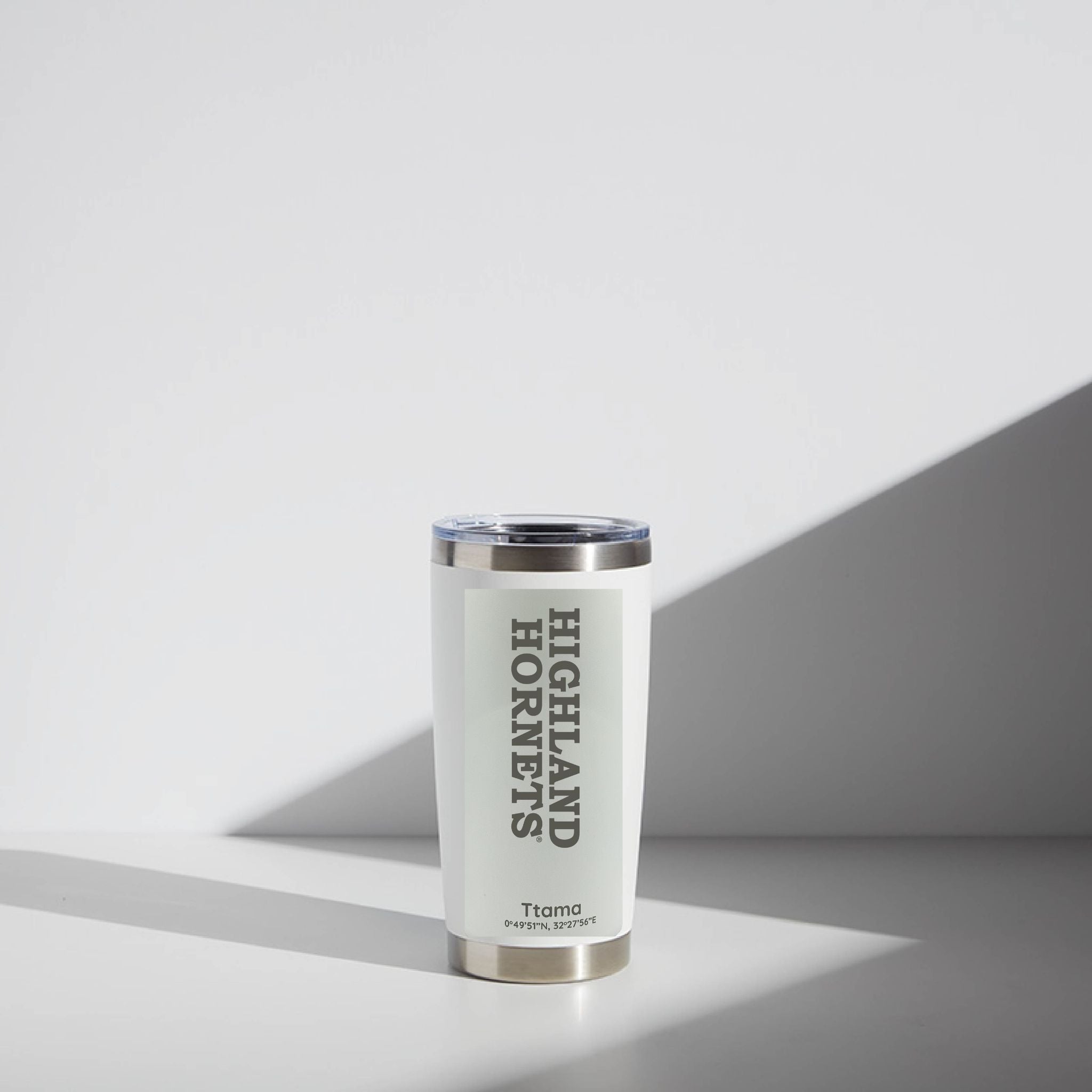 White tumbler with 'Highland Hornets' text on a gray background